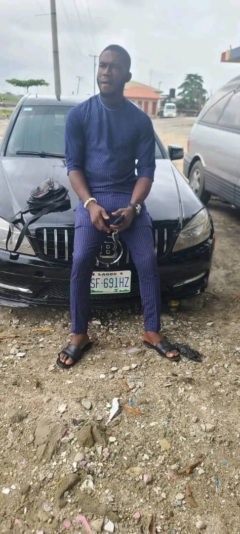 Victor Pedro beside a black car in Lagos
